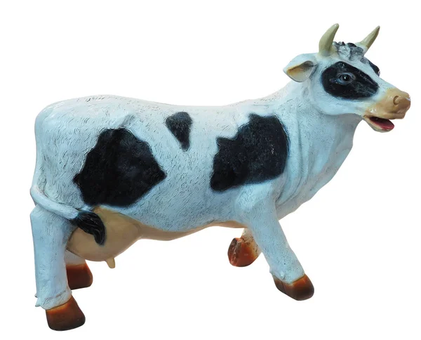 Bianco e nero mucca giocattolo statuetta isolato — Foto Stock