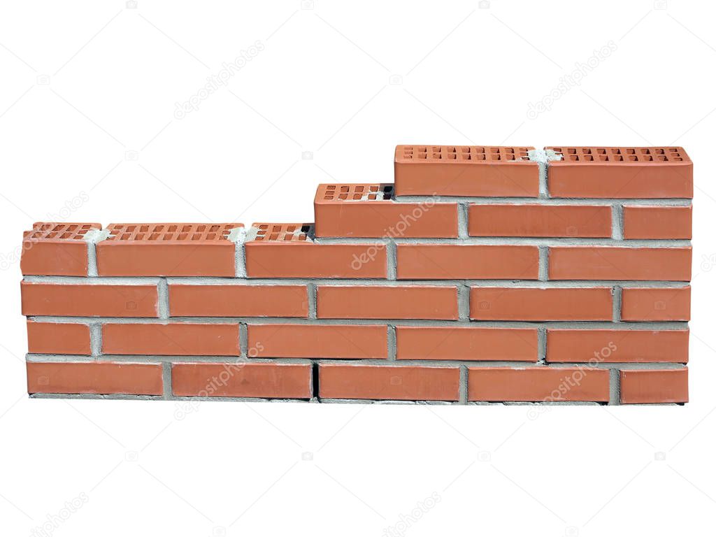 New red brick wall in construction process isolated on white