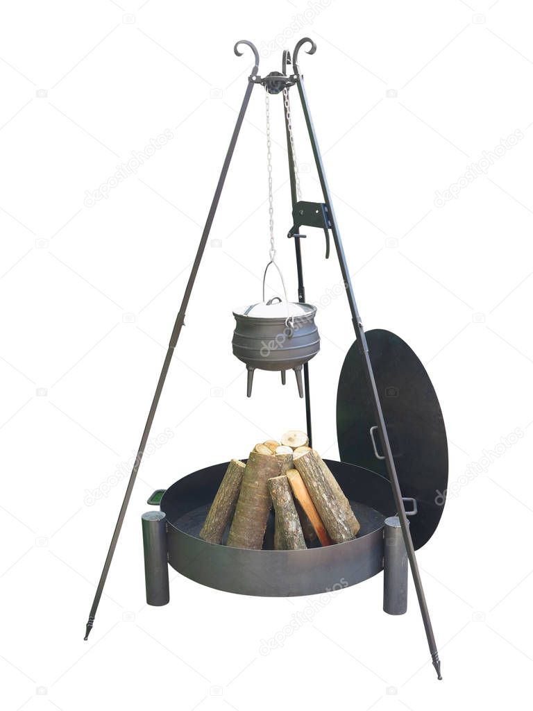 Metallic fire place for camping, firewood and iron pot isolated 
