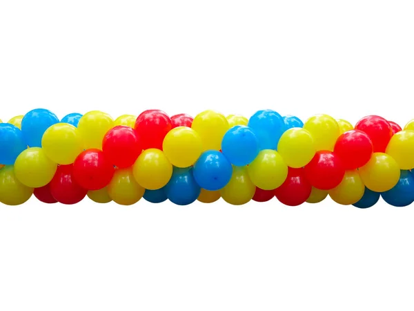 Red, blue and yellow celebration balloons in stack isolated — Stock Photo, Image