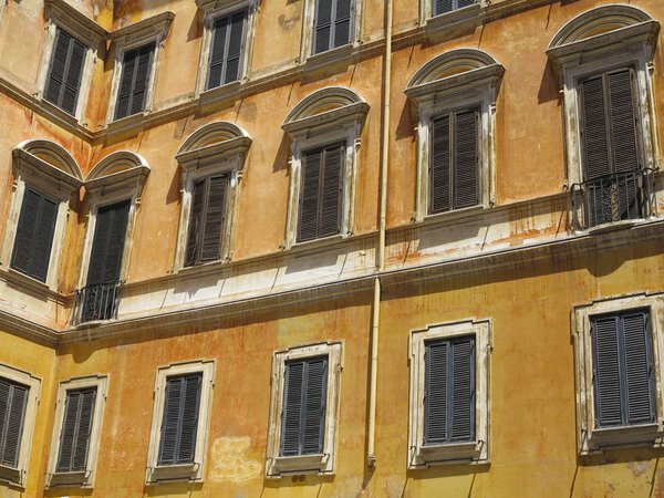 Yellow acade of a classical building in the historical center of Rome, Italy