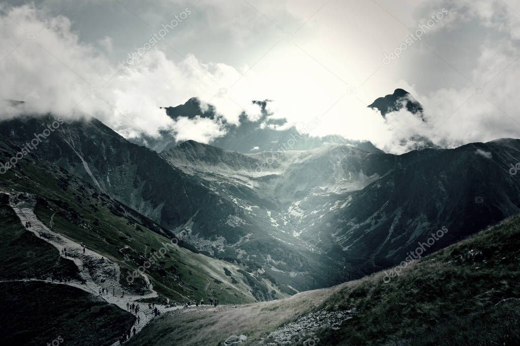 Dark mountains with clouds landscape.