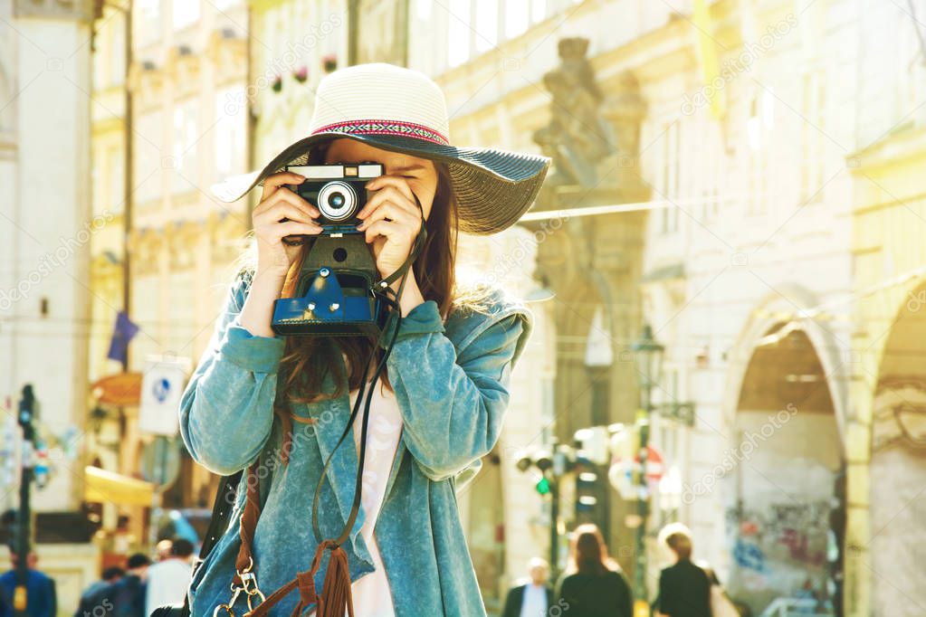 Young hipster girl with old camera.