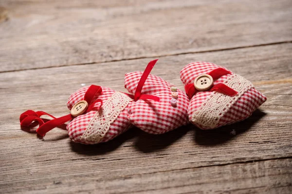 Hearts made of cloth on a wooden background — Stock Photo, Image