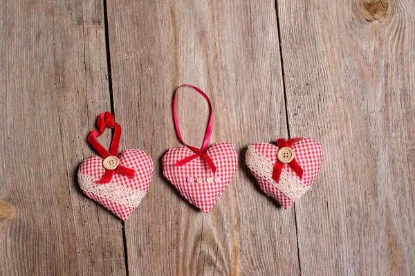 Hearts made of cloth on a wooden background — Stock Photo, Image