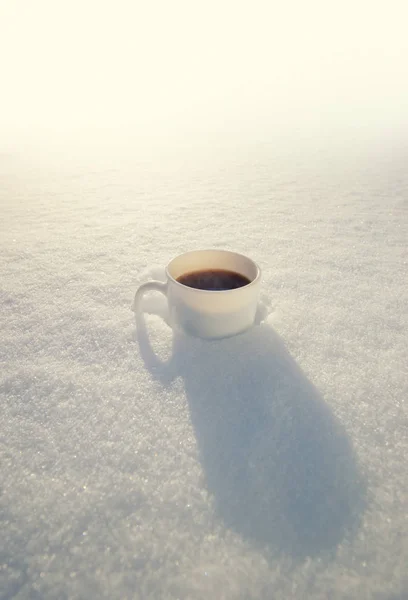 Cup of coffee on snow — Stock Photo, Image