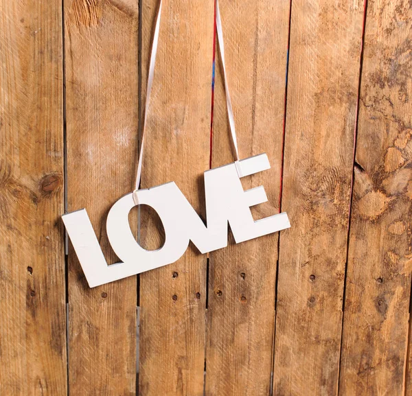 Wooden letters forming word LOVE written on wooden background — Stock Photo, Image