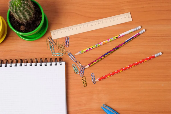 Top view of office tools with blank notebook on wooden table — Stock Photo, Image