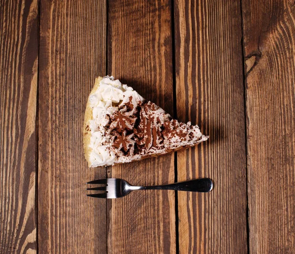 cake with dessert fork on wooden desk