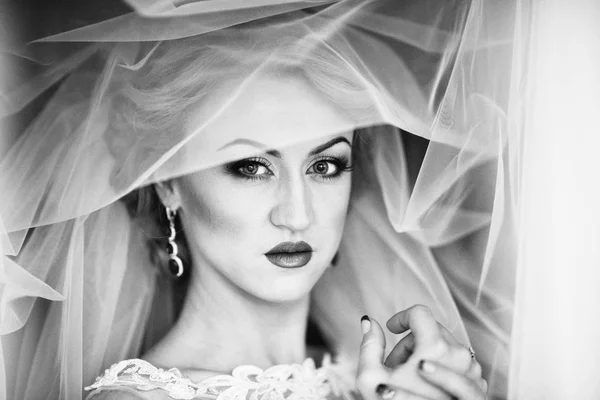 face of a beautiful bride hidden veil