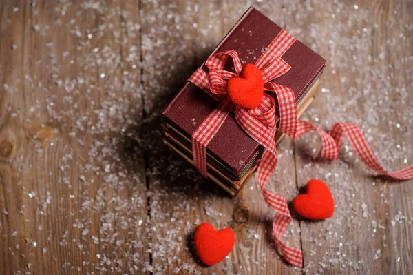 Books Wrapped Color Ribbon Red Hearts Adn Snow Wooden Table — Stock Photo, Image