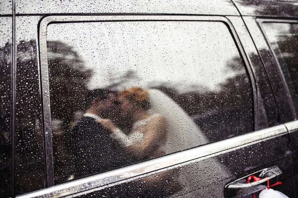 wedding kiss in the rain