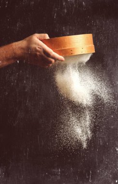 Şef un siyah arka plan üzerinde sifts.