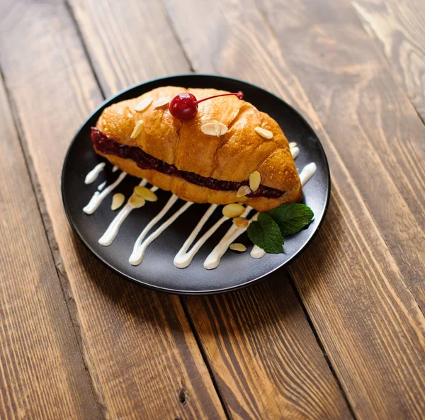 Croissant on the wooden table — Stock Photo, Image