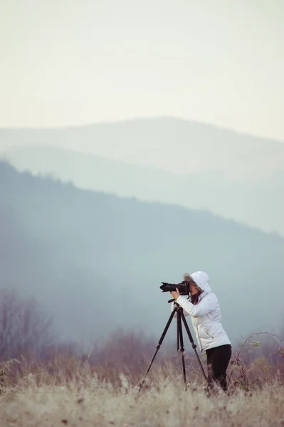 Fotograf mit Kamera und Stativ beim Fotografieren von Landschaft — Stockfoto