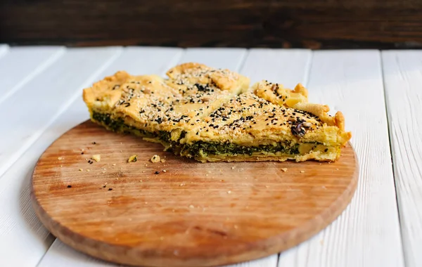 Homemade spinach french pie on a white wooden board — Stock Photo, Image