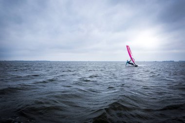 Windsurfer on huge lagoon  clipart