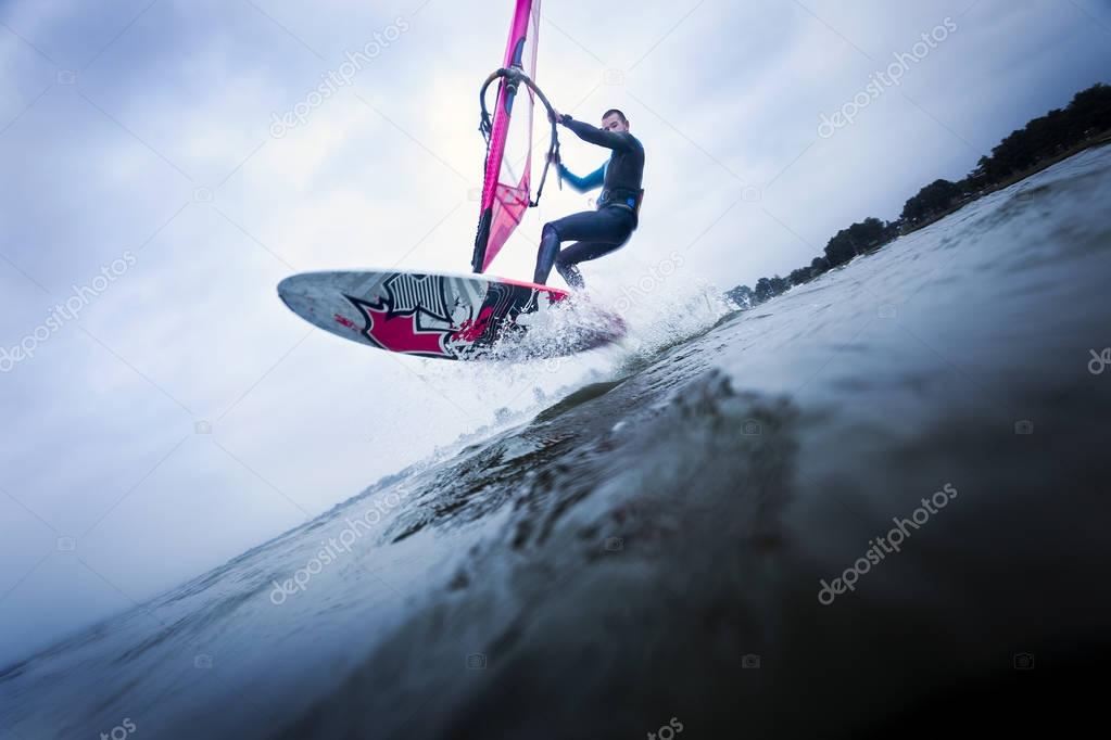 Windsurfer stunting on waves