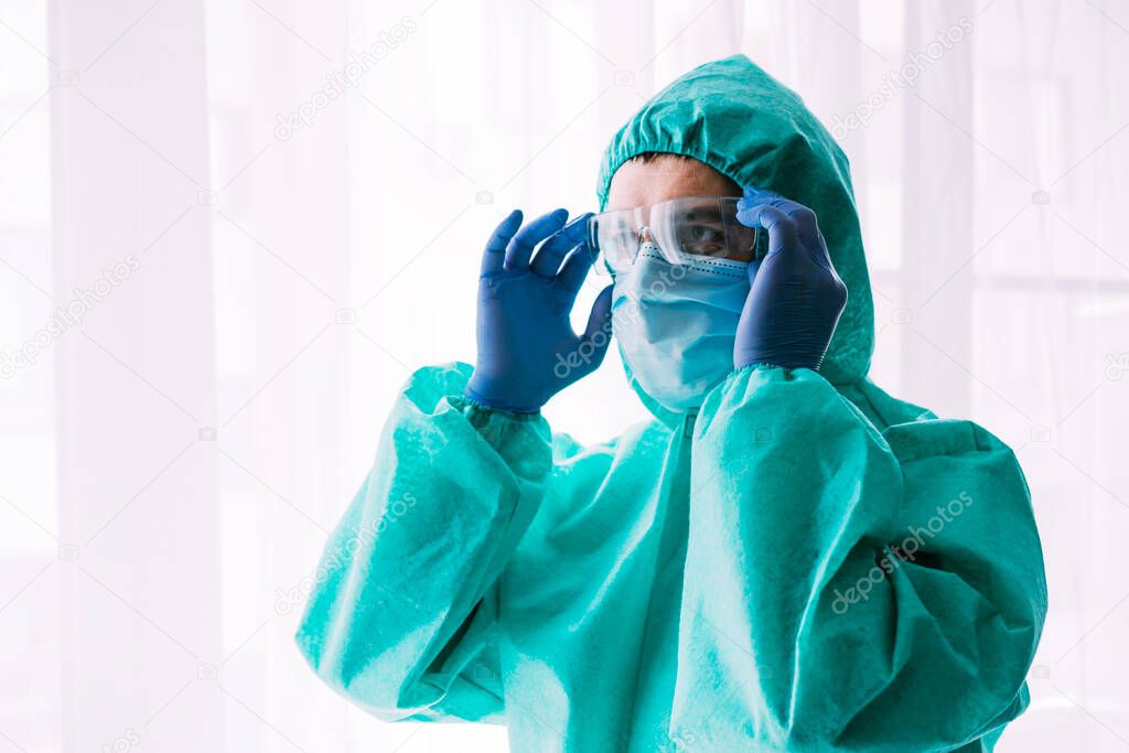 Man doctor or scientist waring protective suit, and face mask 