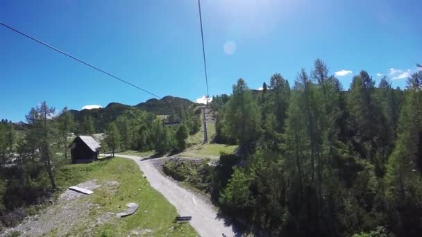 Chairlift cable hoist ride on bright summer day — Stock Video