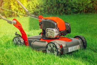 Modern petrol powered rotary push grass lawn mower clipart