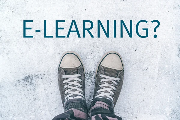 Teenager standing over e-learning title on street — Stock Photo, Image