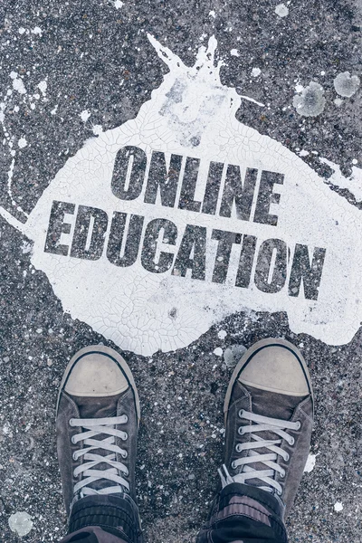 Online education concept with male student feet on the street — Stock Photo, Image