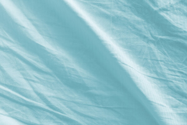Crumpled bed sheets texture as background