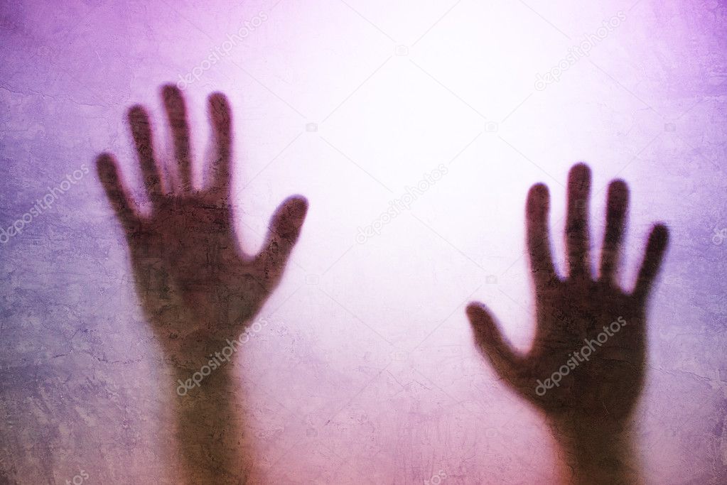 Trapped person, back lit silhouette of hands behind matte glass