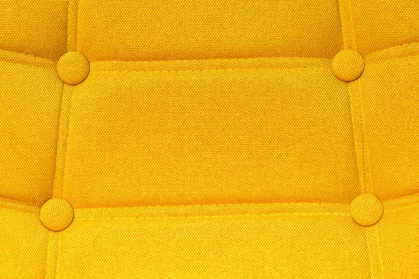 Buttoned yellow chair back support detail — Stock Photo, Image