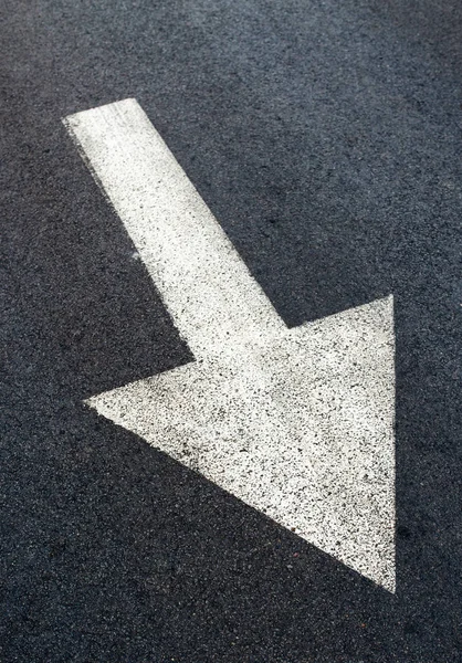 White arrow on asphalt road, traffic sign — Stock Photo, Image