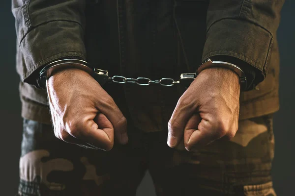 Handcuffed soldier in jail — Stock Photo, Image