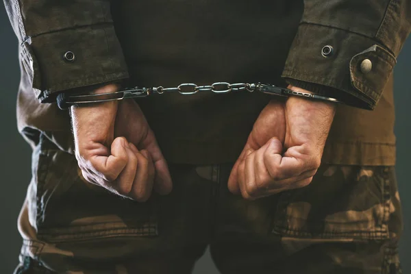 Handcuffed soldier in jail — Stock Photo, Image