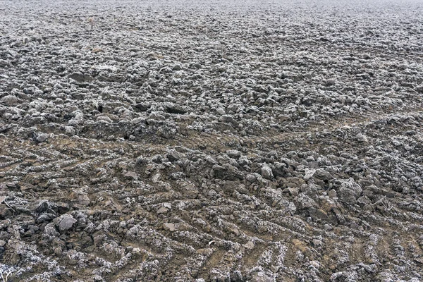Frozen plowed agricultural field covered with frost — Stock Photo, Image