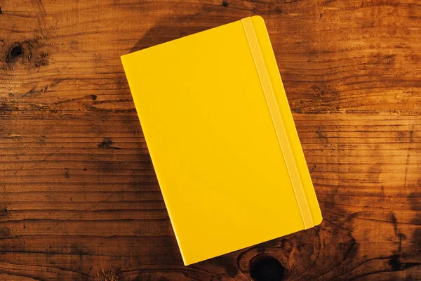 Yellow notebook on office desk, top view — Stock Photo, Image