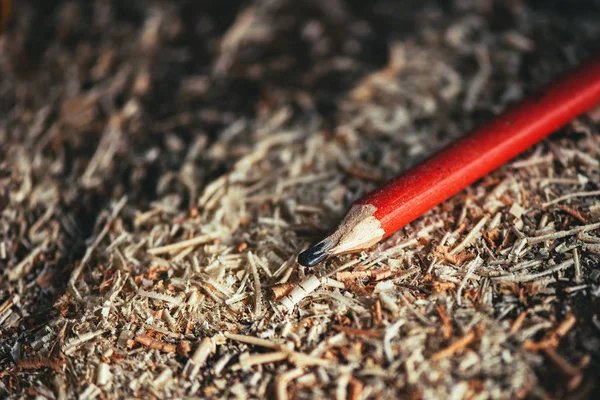 Red pencil on carpenters workshop table — Stock Photo, Image