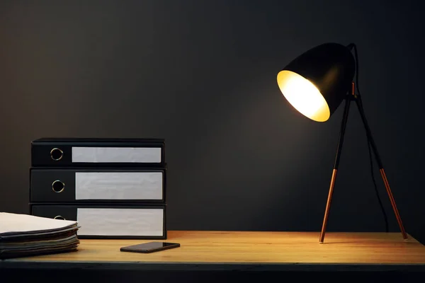 Office desk with lamp and ring binders