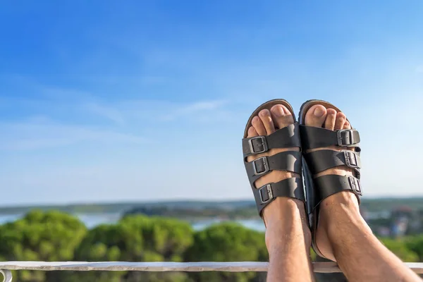 Pieds masculins en pantoufles en cuir relaxant sur balcon — Photo