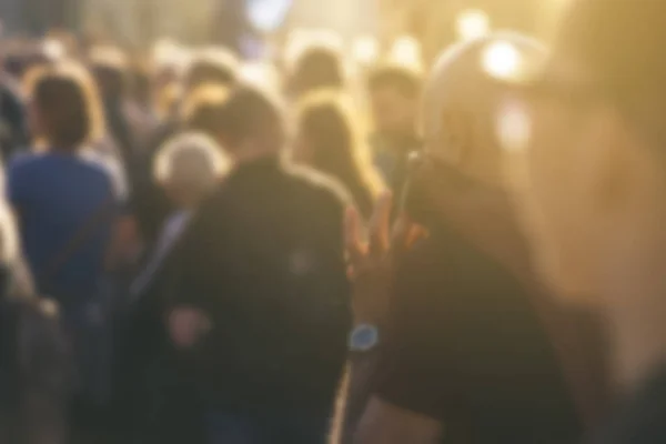 Defocused crowd attending political meeting