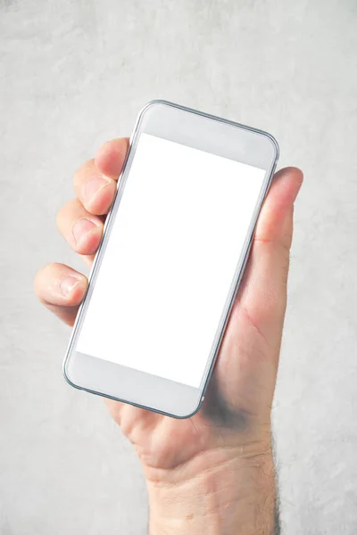 Mão masculina segurando telefone celular com tela em branco mock up — Fotografia de Stock