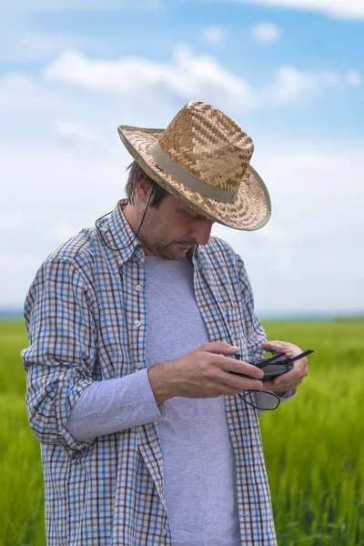 Smart farming concept, farmer using drone in field