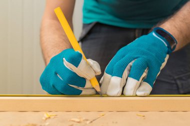 KaIasta işaretlemek için kalem kullanarak marangoz el işleri ustası