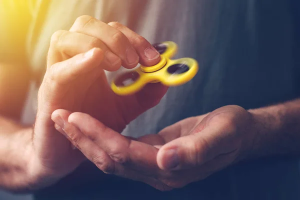 Man playing with fidget spinner — Stock Photo, Image