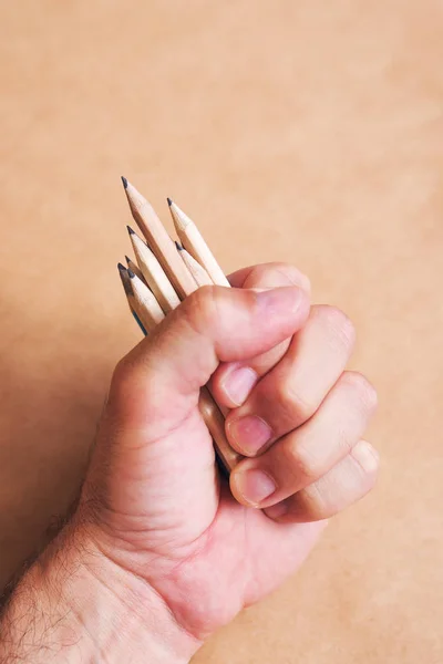 Male illustrator and sketch artist with handful of pencils — Stock Photo, Image