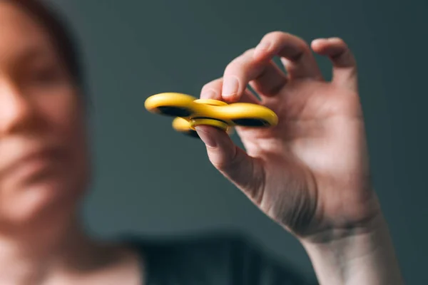 Woman playing with fidget spinner — Stock Photo, Image