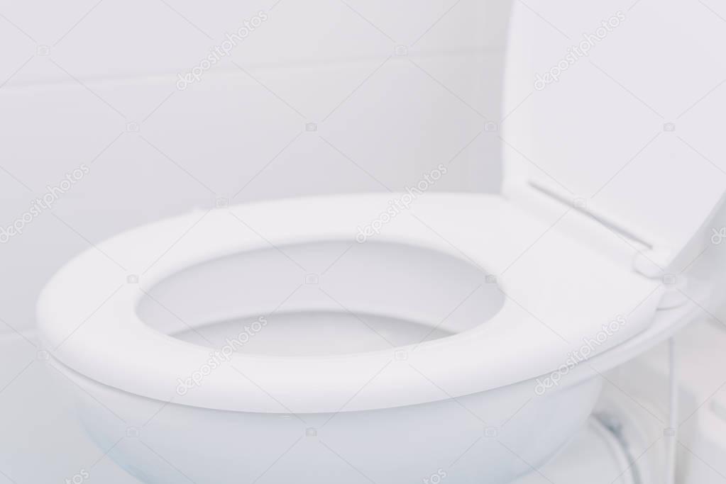 White toilet seat in bathroom