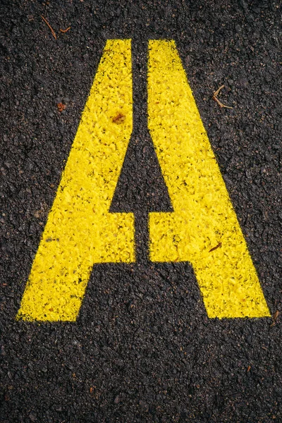 Letter A on asphalt road