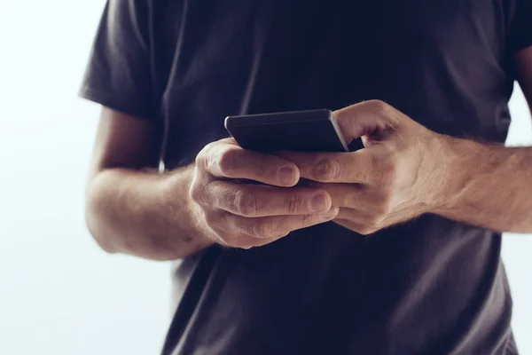 Modern new smartphone in hands of young casual man — Stock Photo, Image