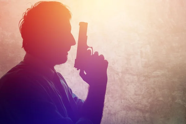 Silhouette of a man with a gun — Stock Photo, Image