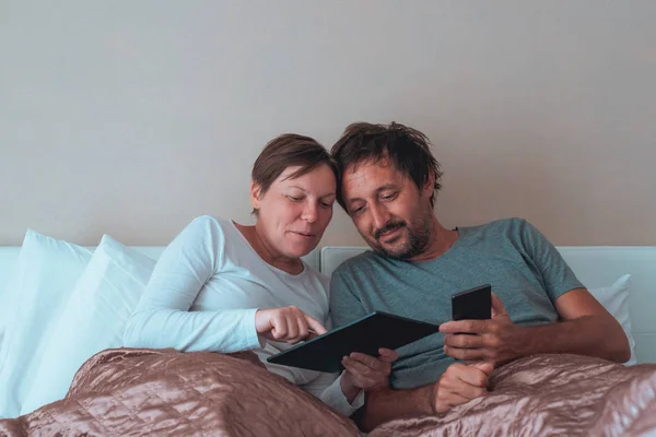 Happy couple, husband and wife in bedroom